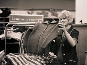 Young saleswoman in the 1968 newly opened consumer department store on Bruehl in Richard-Wagner-Strasse in the center of Leipzig. At that time the largest department store in the GDR, popularly called tin can, because of the aluminum shell of the outer facade made in honeycomb patterns, which unfortunately heated up the house very much. Young saleswoman in the 1968 newly opened consumer department store on Bruehl in Richard-Wagner-Strasse in the center of Leipzig. At that time the largest department store in the GDR, popularly called tin can, because of the aluminum shell of the outer facade made in honeycomb patterns, which unfortunately heated up the house very much.
